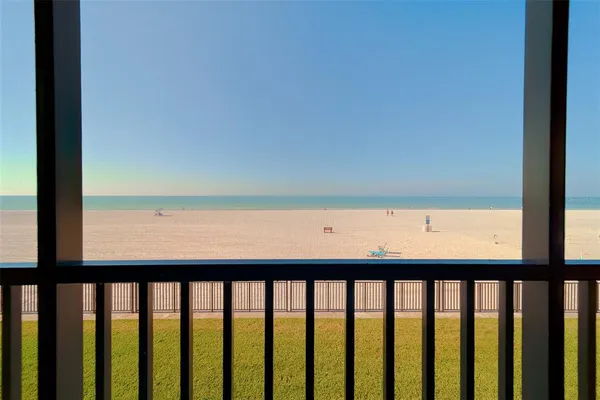 a view of a balcony with wooden floor and fence