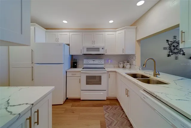 a kitchen with a sink stainless steel appliances and cabinets