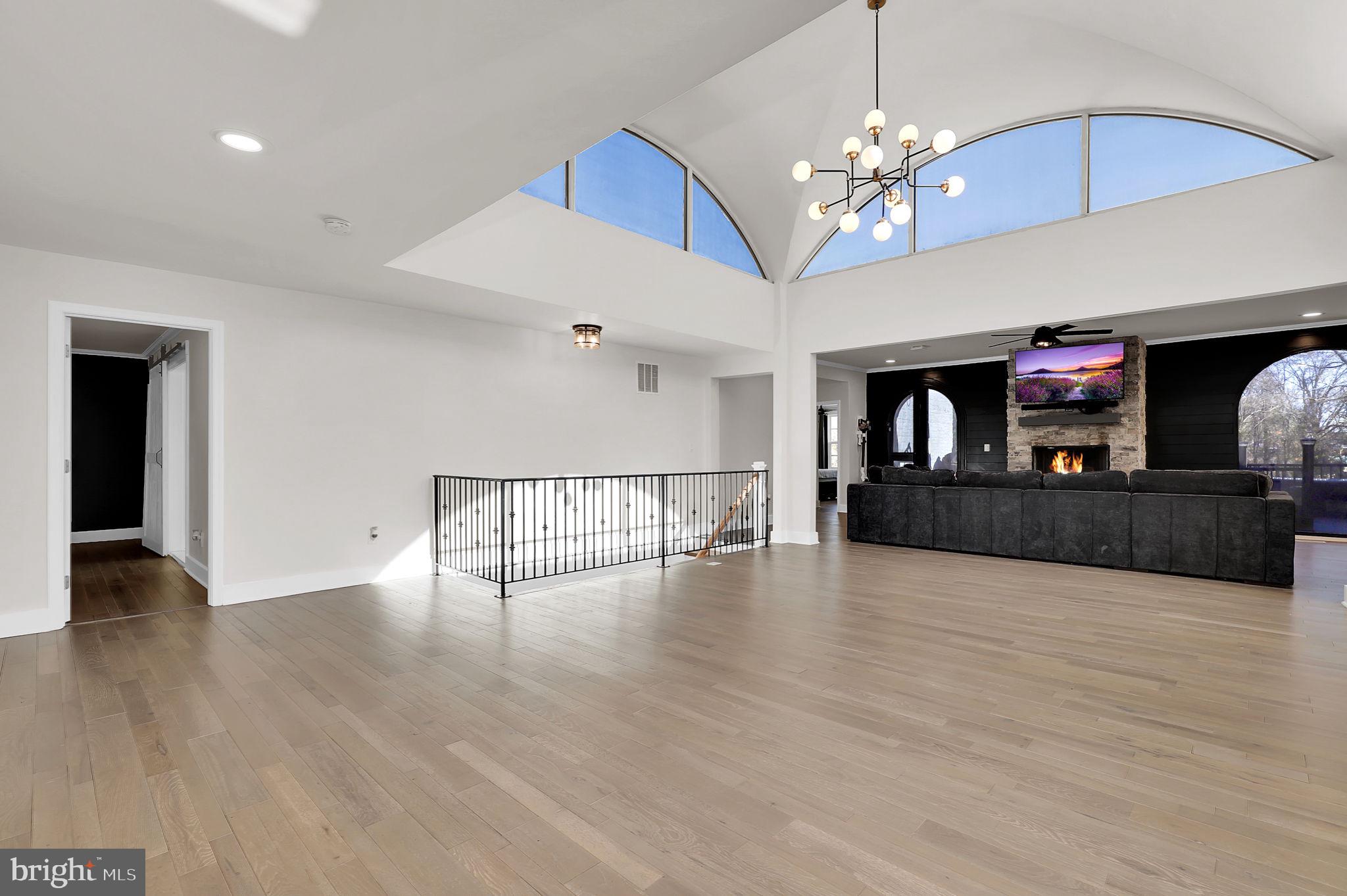 2919 Davidsonville Road Davidsonville, MD 21035 - Photo 11 of 63 a view of a livingroom with wooden floor and chandelier