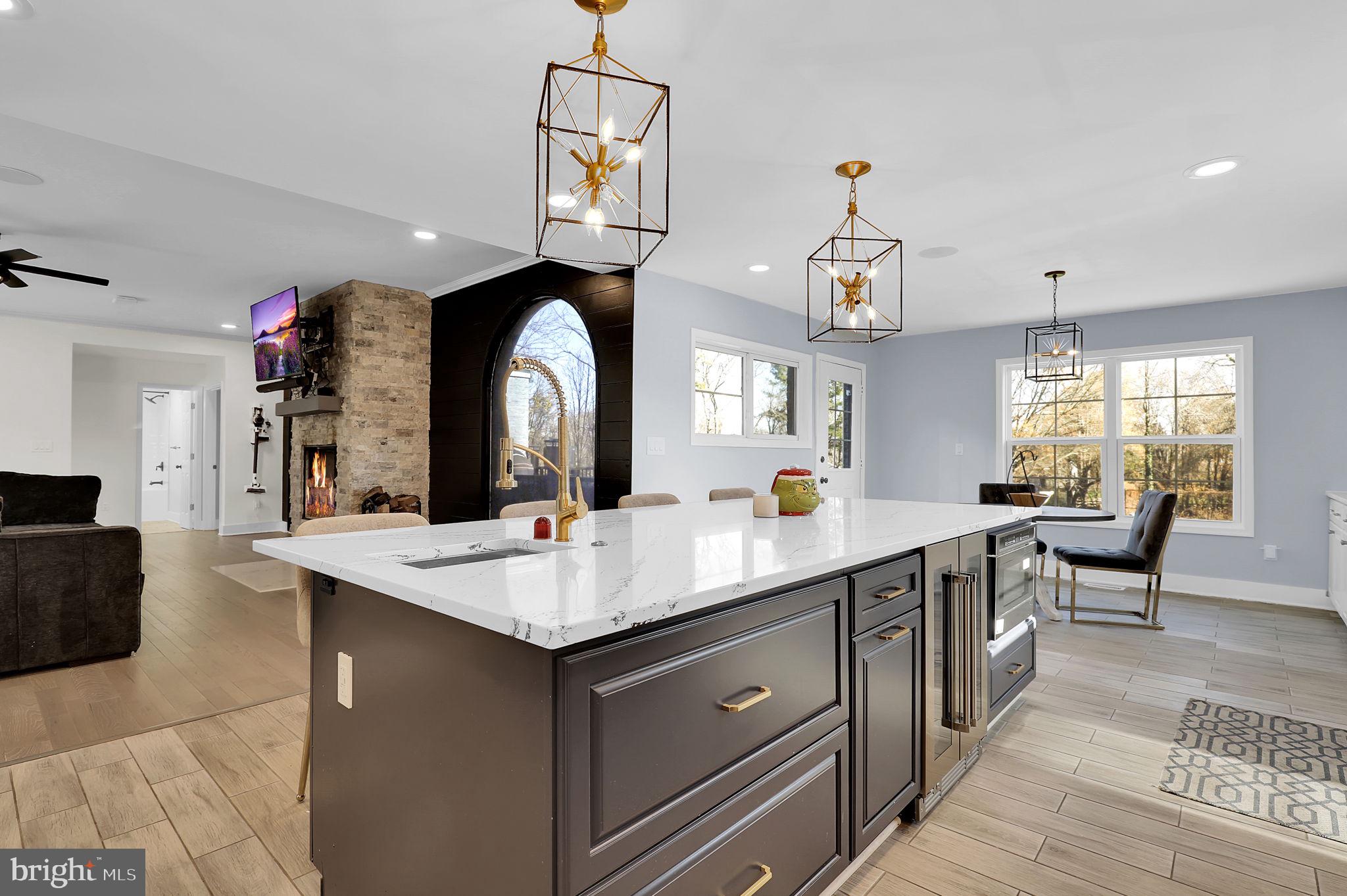 2919 Davidsonville Road Davidsonville, MD 21035 - Photo 18 of 63 a open kitchen with stainless steel appliances granite countertop a sink dishwasher a dining table and chairs with wooden floor