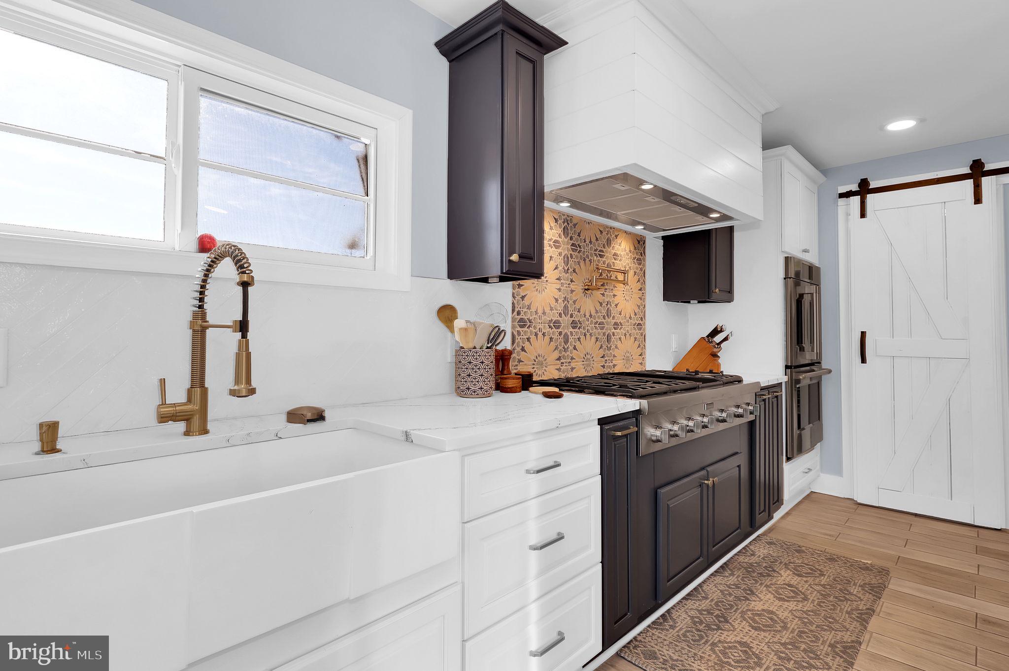 2919 Davidsonville Road Davidsonville, MD 21035 - Photo 20 of 63 a kitchen with stainless steel appliances granite countertop a sink stove and refrigerator