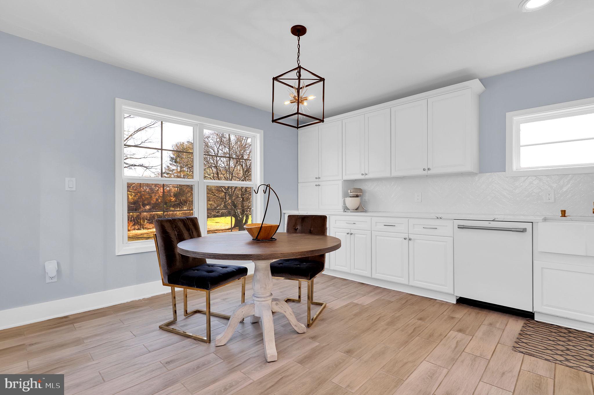 2919 Davidsonville Road Davidsonville, MD 21035 - Photo 23 of 63 a view of a dining room with furniture window and wooden floor