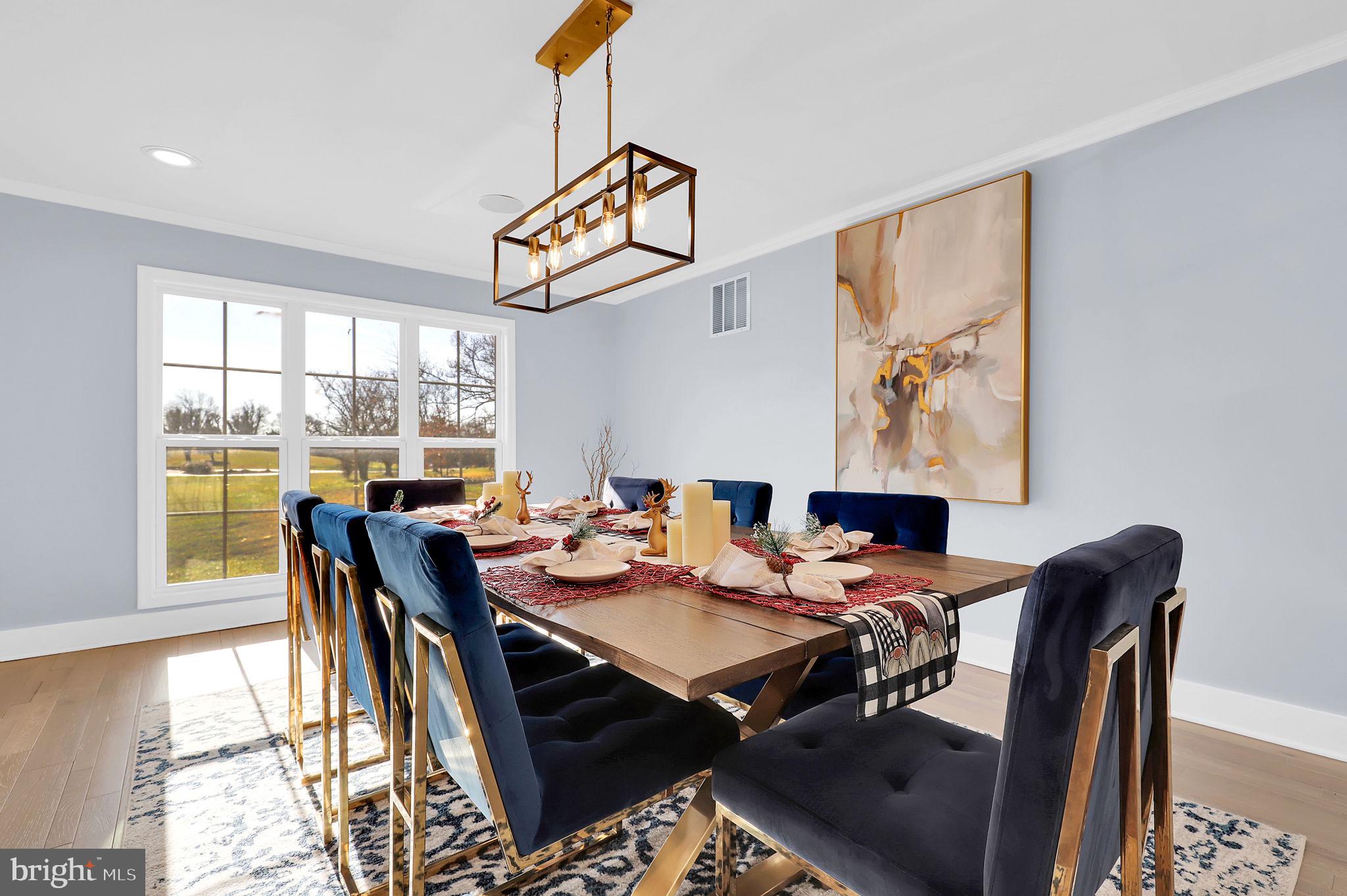 2919 Davidsonville Road Davidsonville, MD 21035 - Photo 24 of 63 a view of a dining room and livingroom with furniture wooden floor and a rug