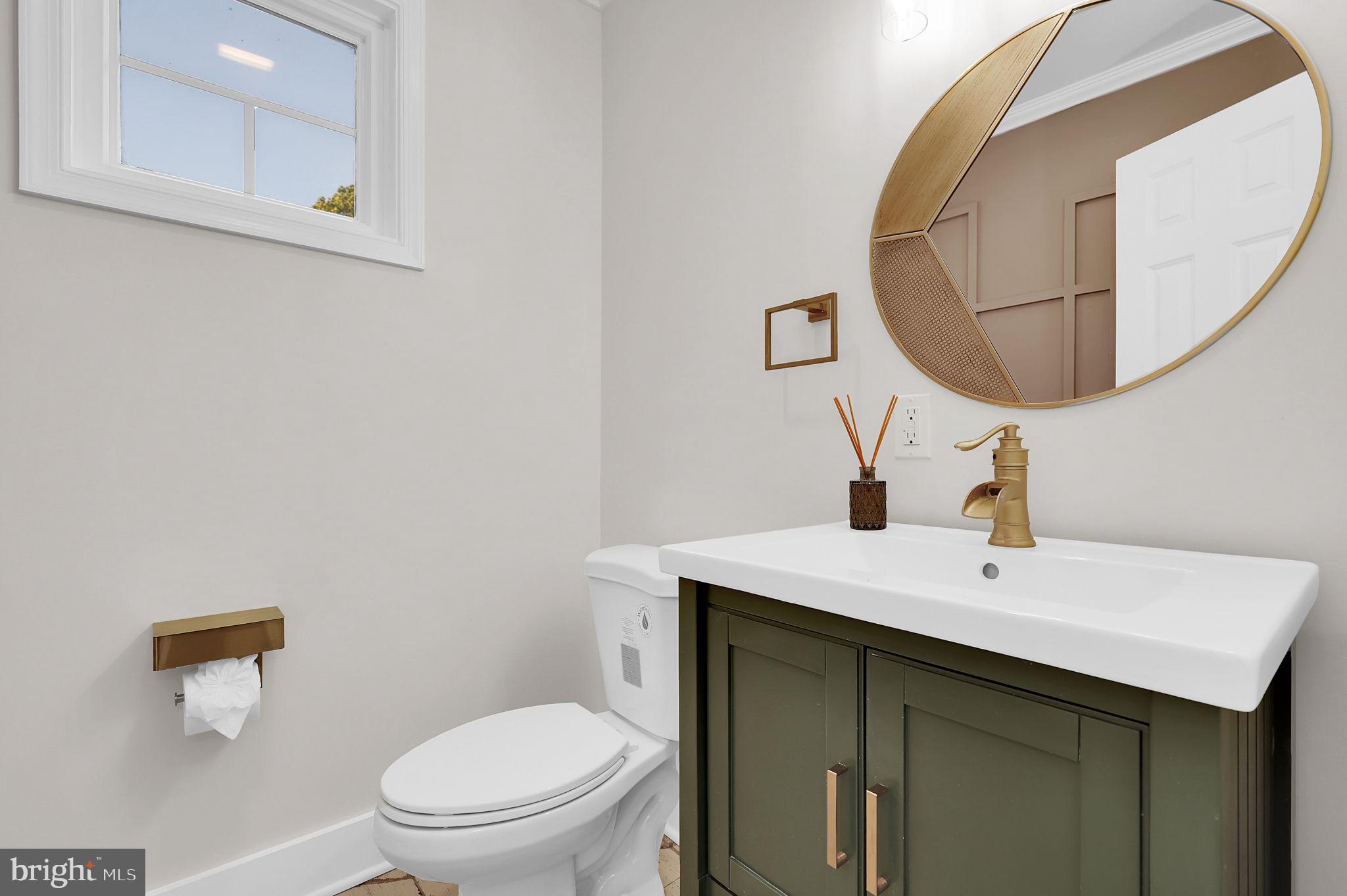 2919 Davidsonville Road Davidsonville, MD 21035 - Photo 26 of 63 a bathroom with a sink a mirror and a toilet