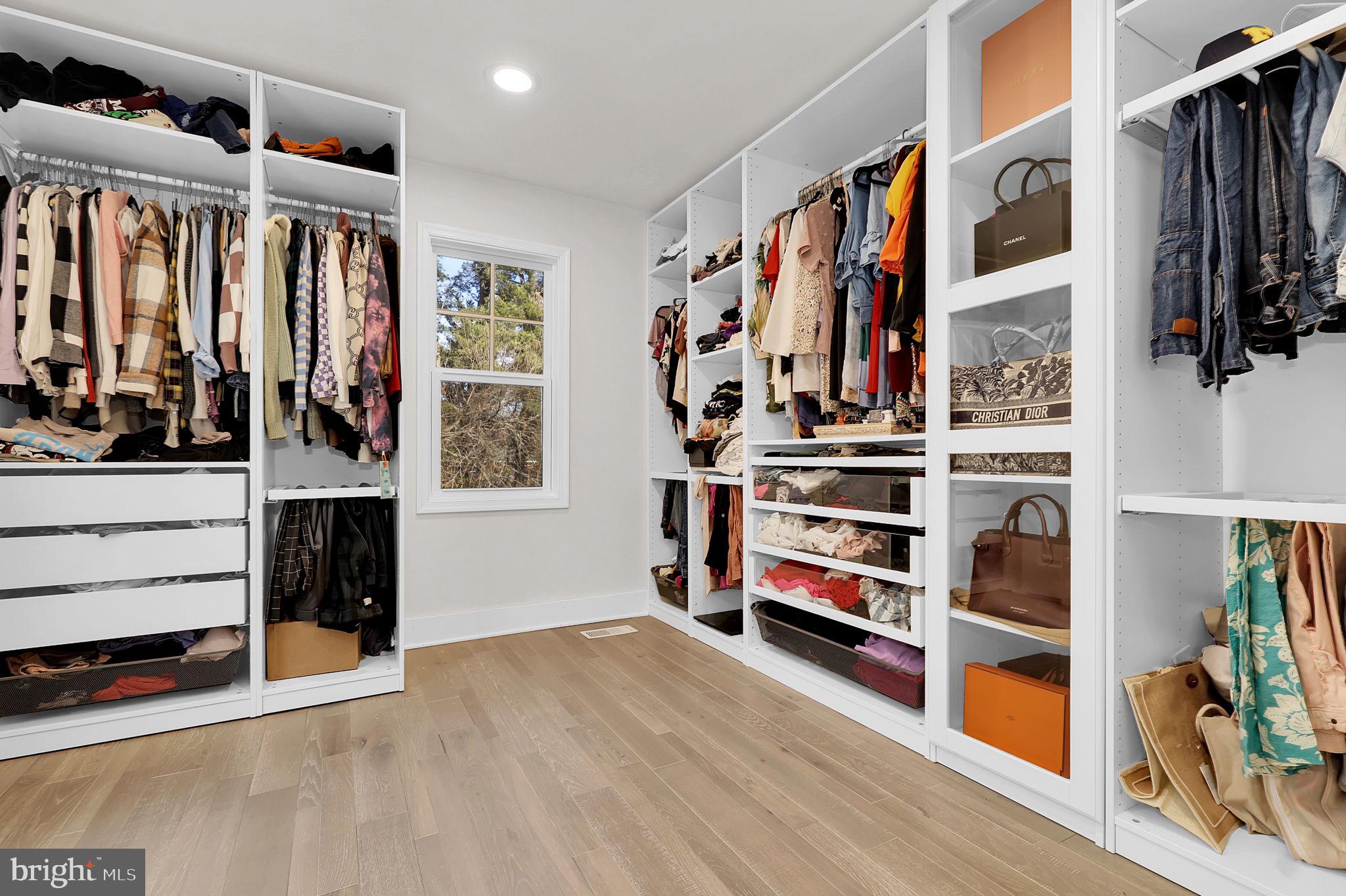 2919 Davidsonville Road Davidsonville, MD 21035 - Photo 32 of 63 a view of walk in closet with clothes and shoes