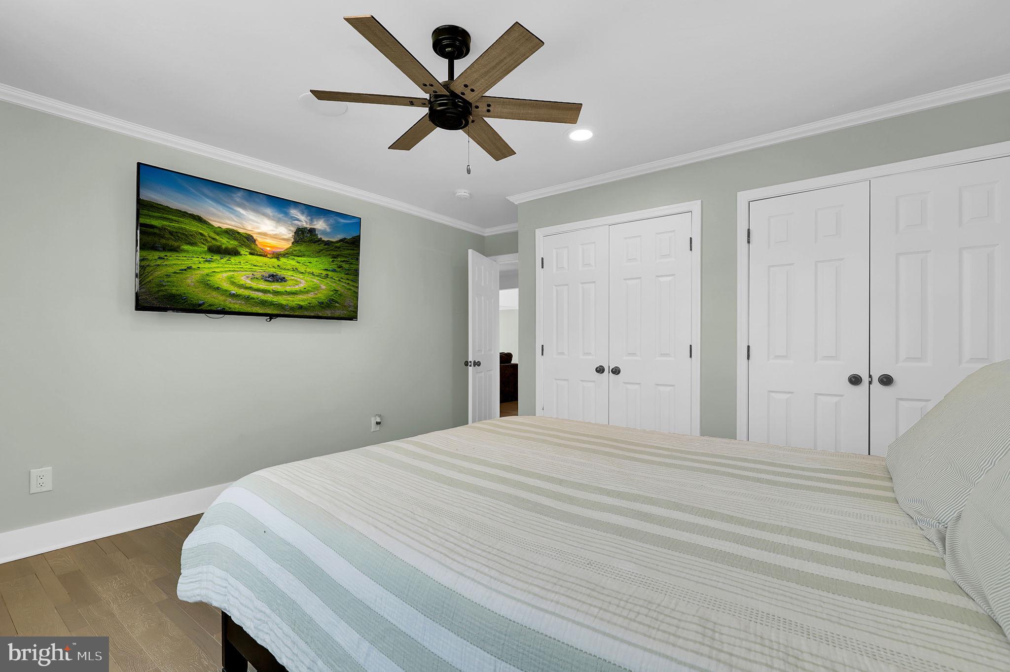 2919 Davidsonville Road Davidsonville, MD 21035 - Photo 37 of 63 a bedroom with a bed and a chandelier