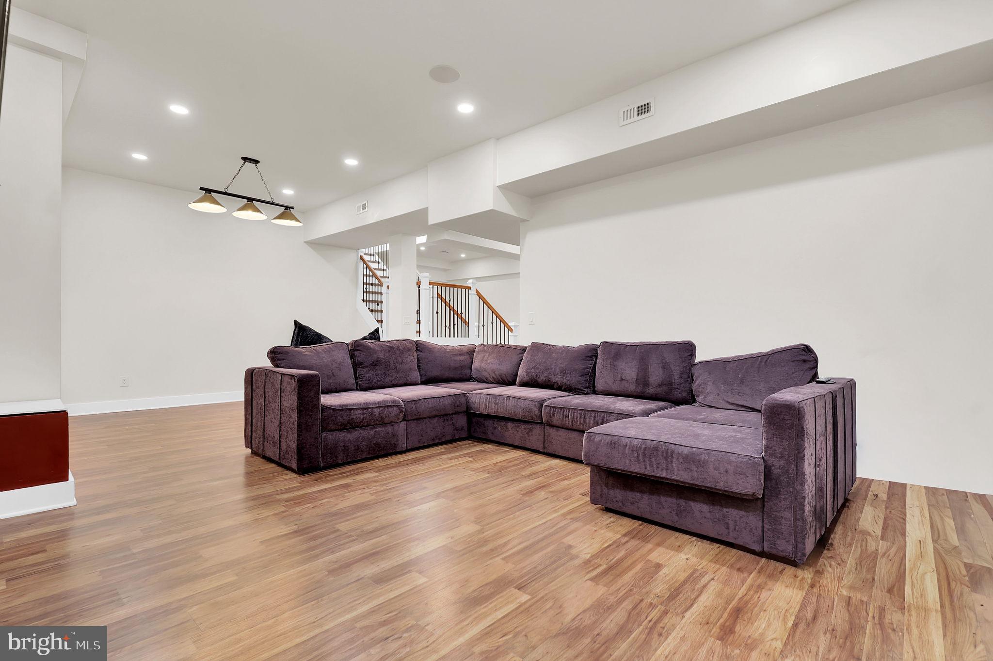 2919 Davidsonville Road Davidsonville, MD 21035 - Photo 42 of 63 a living room with furniture and a wooden floor