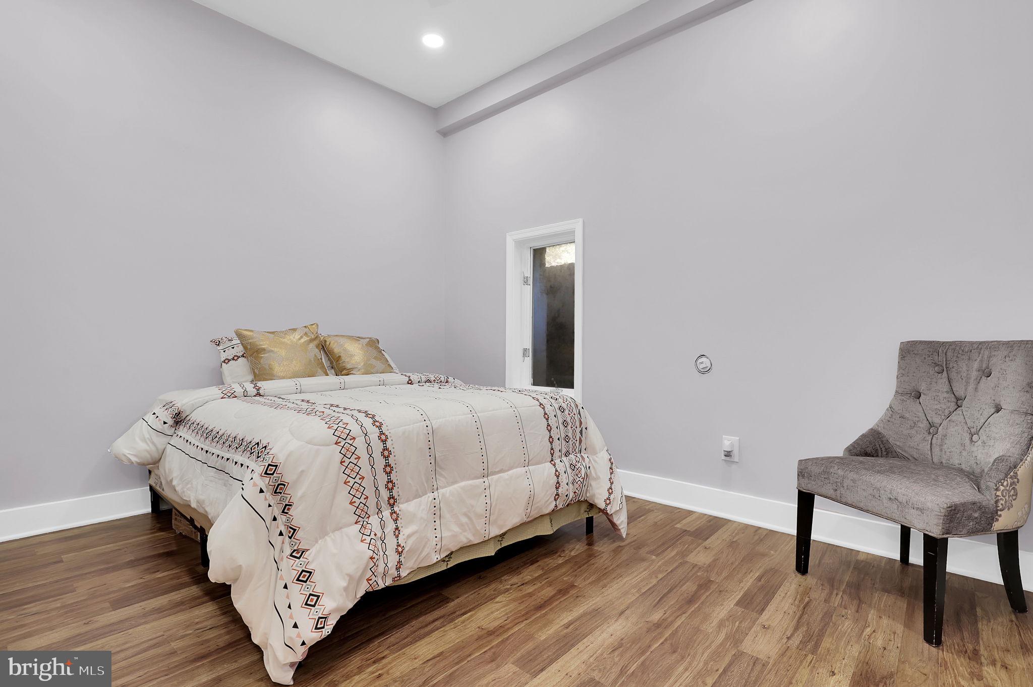 2919 Davidsonville Road Davidsonville, MD 21035 - Photo 45 of 63 a bedroom with a bed and wooden floor