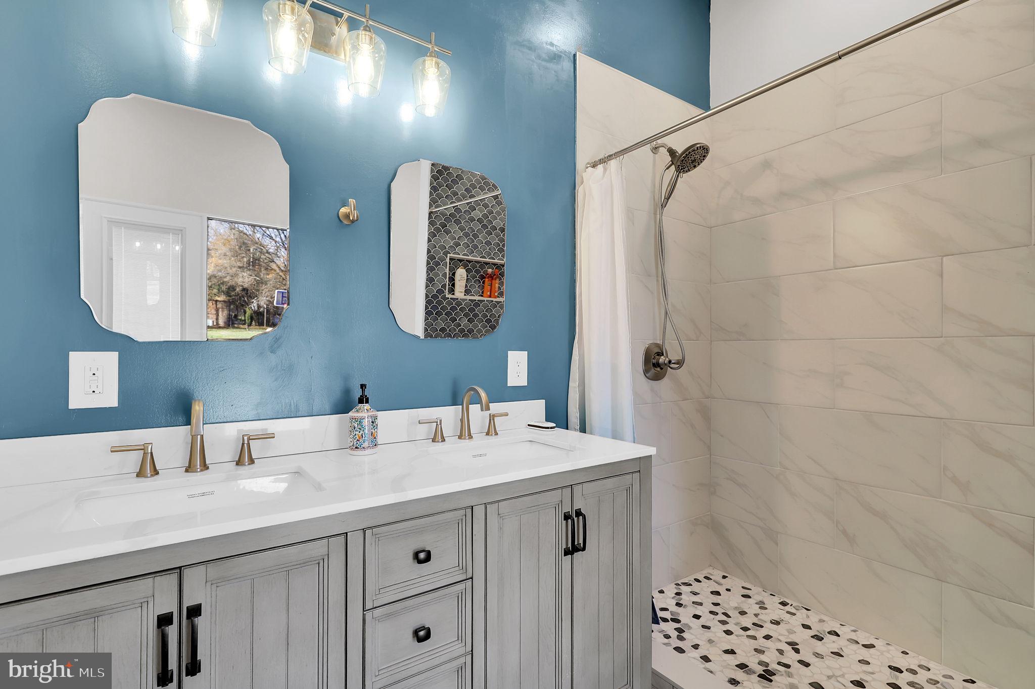 2919 Davidsonville Road Davidsonville, MD 21035 - Photo 49 of 63 a bathroom with a sink a vanity and a mirror