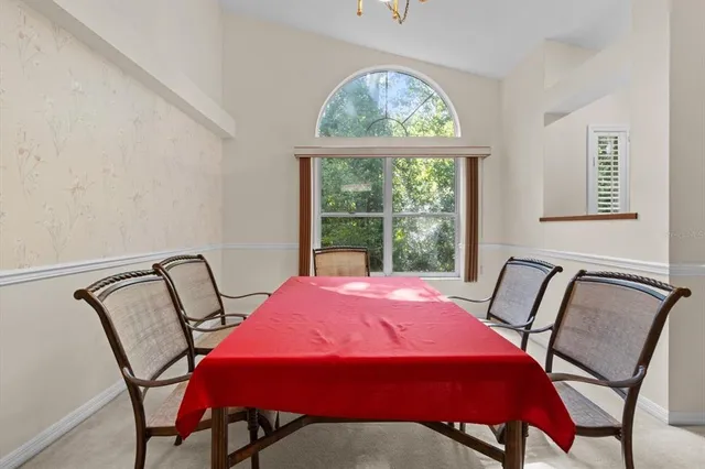 a living room with furniture a chandelier and a chair