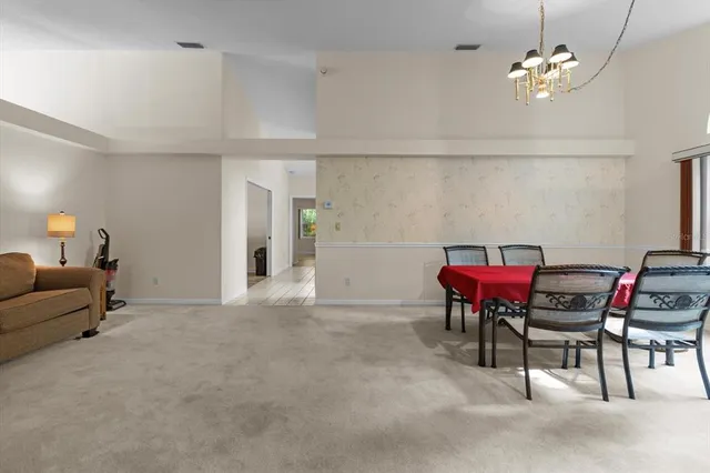 a bedroom with furniture and a large window