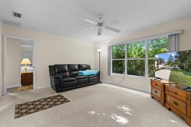 a open kitchen with stainless steel appliances granite countertop a stove top oven a sink dishwasher and white cabinets with wooden floor