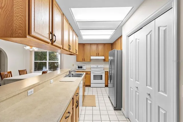 a kitchen with a sink a refrigerator and cabinets