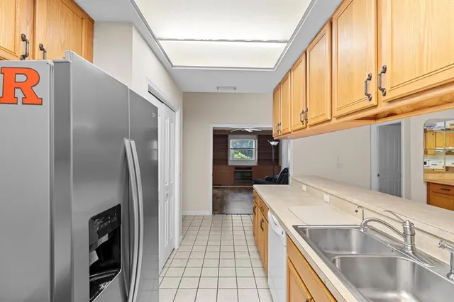 a view of a kitchen with stainless steel appliances wooden cabinets and a counter top