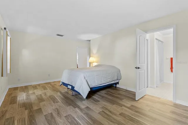 a bathroom with a granite countertop toilet a sink and a mirror