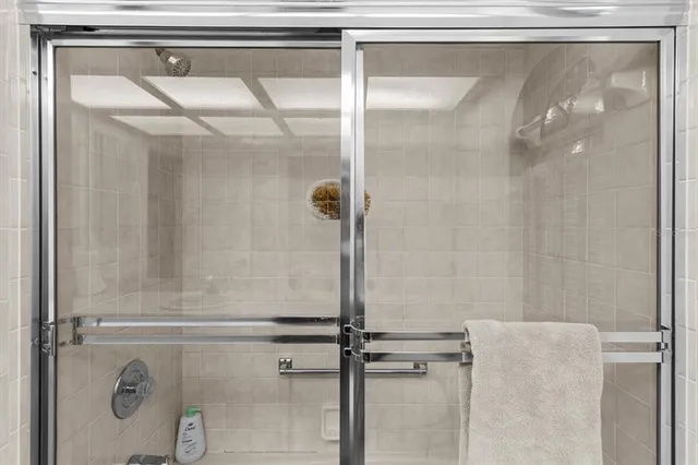 a bedroom with a bed a desk and chair with the wooden floor