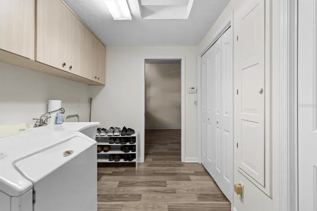 a utility room with a sink dryer and washer