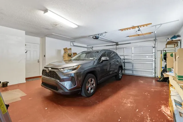 a view of hallway with chair and wooden floor