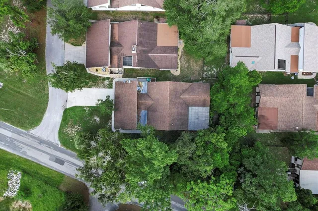 an aerial view of residential houses with outdoor space and street view