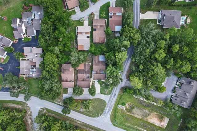 an aerial view of a houses with a yard