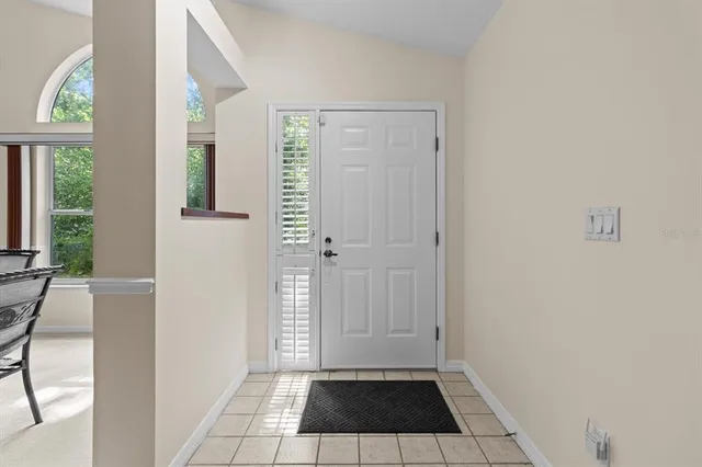 a bedroom with a bed a table and chair