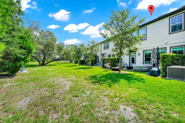 a view of a house with backyard and sitting area