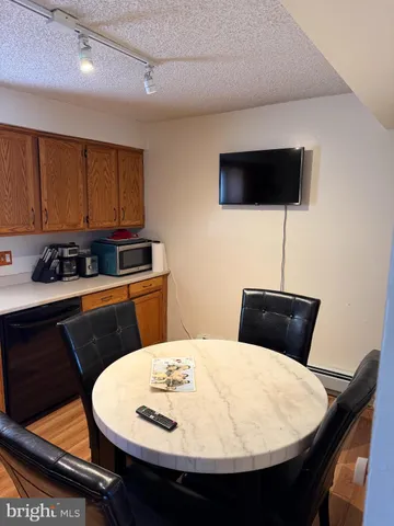 a kitchen with a table and chairs