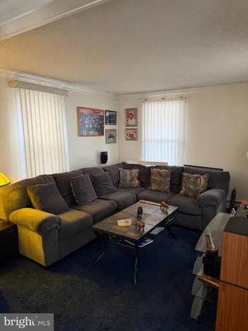 a living room with a couch and a window