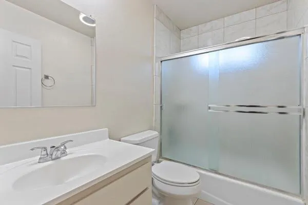 a bathroom with a sink a mirror and a toilet