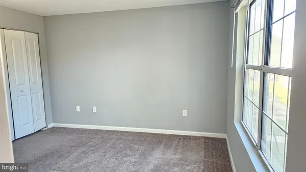 an empty room with windows and entrance