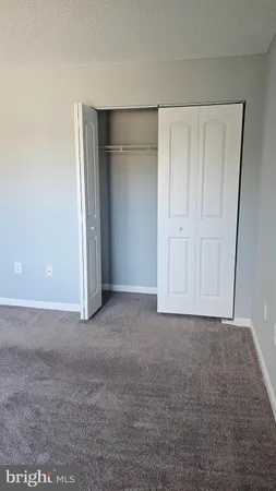 a view of an empty room and closet area