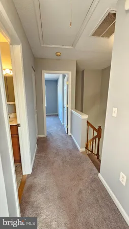 a view of a hallway view with wooden floor and staircase