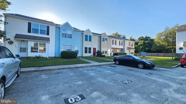 a view of a house with a backyard and a tree