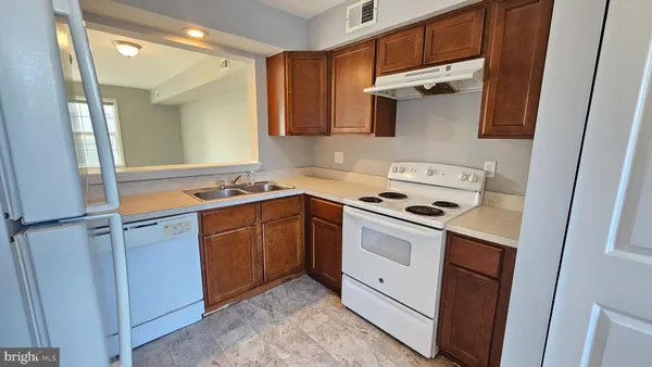a kitchen with stainless steel appliances a stove a microwave and a refrigerator