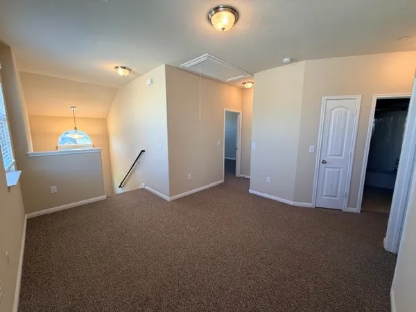 a view of a livingroom with a ceiling fan and window