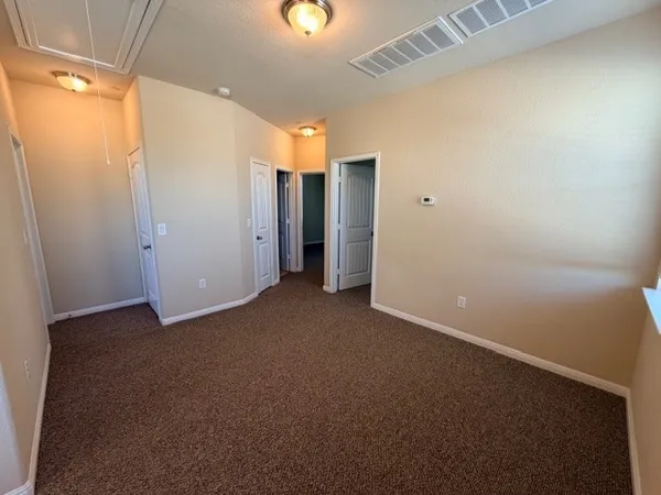a view of an empty room and a window