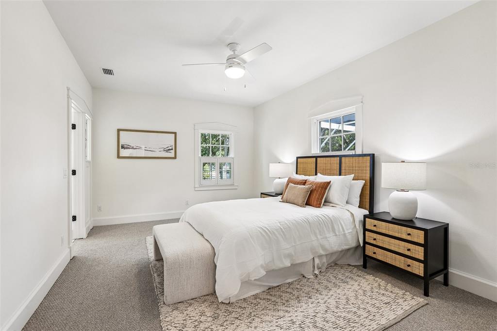 1012 Morfield Lane Brandon, FL 33511 - Photo 63 of 100 a bedroom with a bed and a chandelier