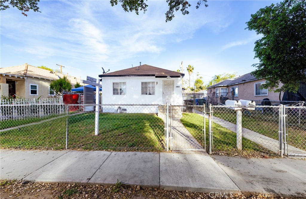 4156 Dwight Avenue Riverside, CA 92507 - Photo 3 of 8 a front view of a house with a yard table and chairs