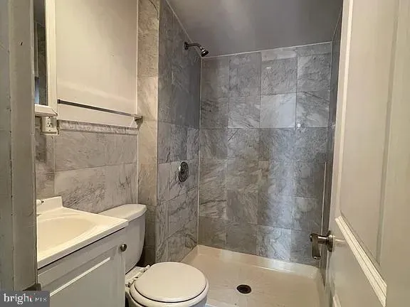 a bathroom with a shower a toilet and a sink