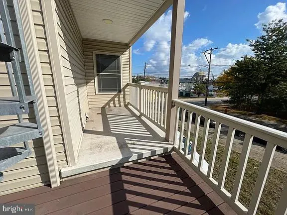 a view of balcony with wooden floor and fence