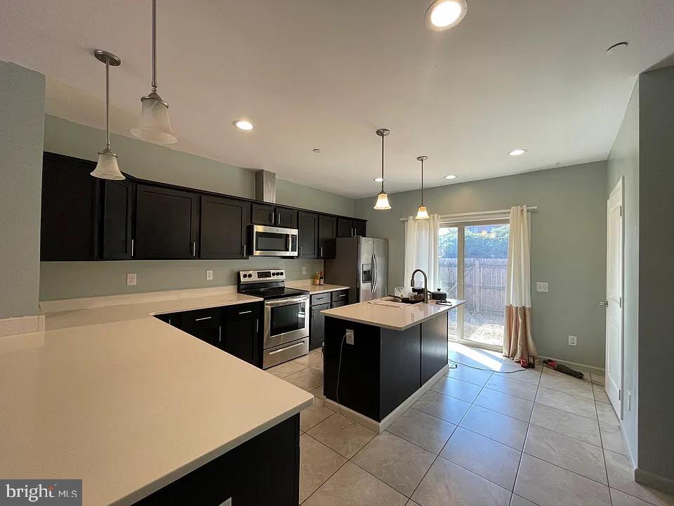 1002 Fairmount Avenue Philadelphia, PA 19123 - Photo 4 of 17 a kitchen with stainless steel appliances granite countertop a sink a stove and a refrigerator