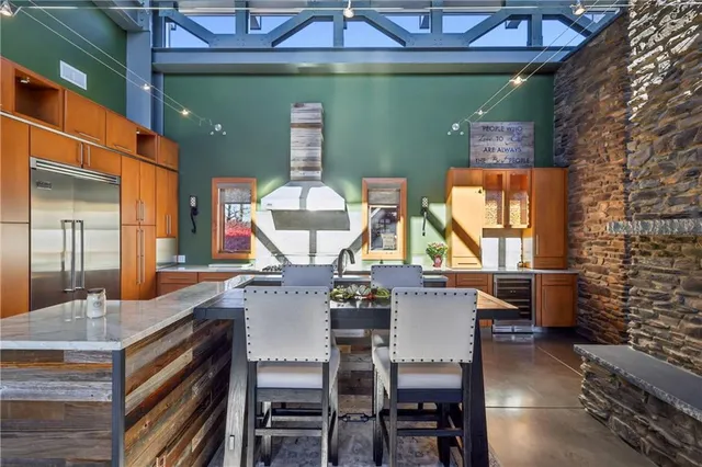 a large kitchen with stainless steel appliances granite countertop a sink and a stove