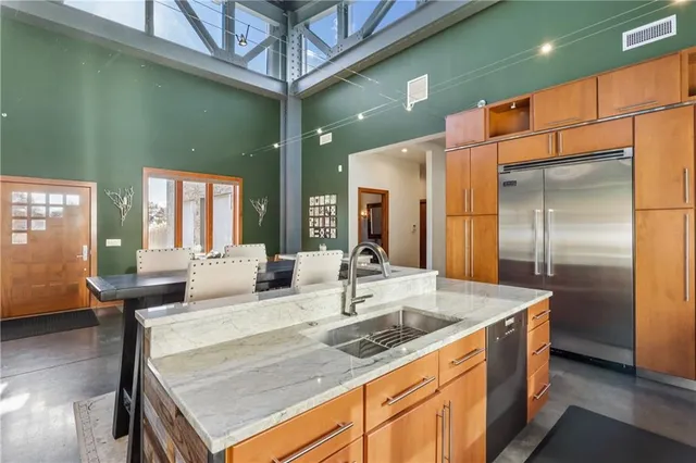 a kitchen with stainless steel appliances granite countertop a stove and a refrigerator