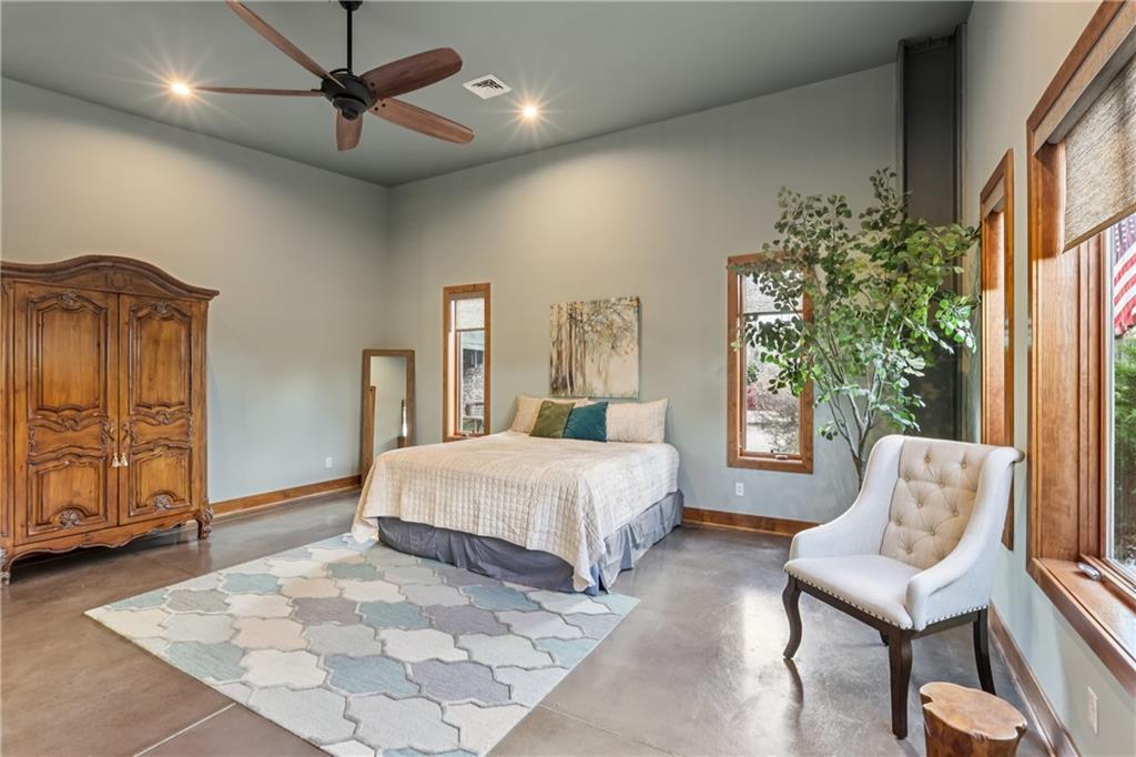 461 Dutchman Run Road New Kensington, PA 15068 - Photo 29 of 50 a spacious bedroom with a large bed a chandelier and windows