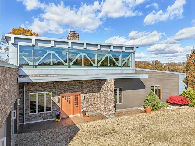 a view of a patio with couches table and chairs and potted plants