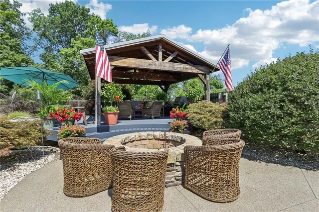 a view of a patio with a table and chairs in front of it