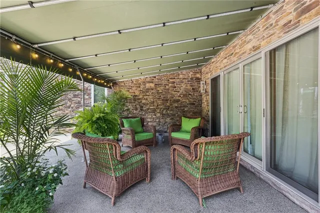 a view of a patio with table and chairs under an umbrella