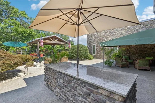 a view of a chairs and table in a backyard