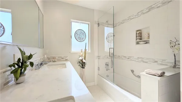 a bathroom with a tub sink and mirror