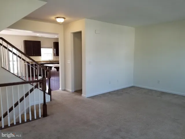 a view of an empty room with staircase